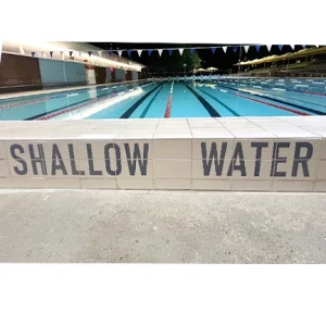 Custom ceramic pool message tile designed for hotels, schools and public aquatic facilities.